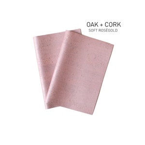 May include: Two pieces of pink cork fabric with a subtle sparkle, folded together. The fabric is labelled "OAK + CORK SOFT ROSÉGOLD".