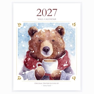 May include: A 2027 wall calendar featuring a watercolour illustration of a brown bear wearing a red scarf and a grey jumper, holding a white mug. The background shows a blue snowy scene. The text reads 2027 WALL CALENDAR and ORIGINAL WATERCOLOURS BY: Terra Nord.