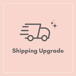 May include: A line drawing of a delivery truck with stars above it, indicating fast shipping. The text "Shipping Upgrade" is below the truck.
