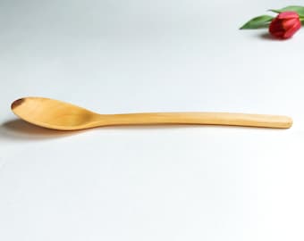 Bright side of plum wood, handcrafted, feather light table spoon with elegant, thin handle.