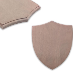 May include: Two unfinished wooden plaques. One is shield-shaped, and the other has a curved top. Both are made of light-colored wood, possibly birch or maple, and are ready for painting or staining. The shield plaque is approximately 10 inches tall.