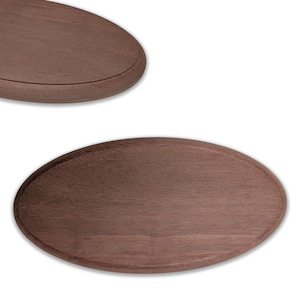 May include: Two oval-shaped wooden serving boards. The boards are a medium brown color with a smooth surface and a slightly raised edge. The boards are likely used for serving food or as decorative pieces.
