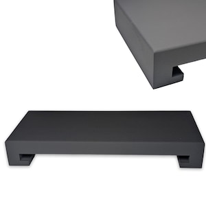 May include: A rectangular, dark gray wooden shelf with a recessed design on each end. The shelf is shown in two views, one from the top and another from a slightly angled perspective. The shelf is a solid color and has a matte finish.