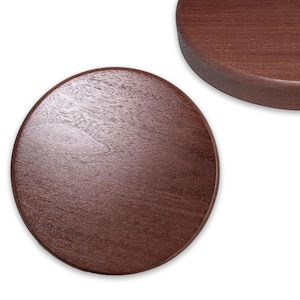 May include: Two round, wooden coasters with a rich, dark brown finish. The coasters have a smooth, polished surface, showcasing the natural wood grain. One coaster is fully visible, while the other is partially seen in the background.