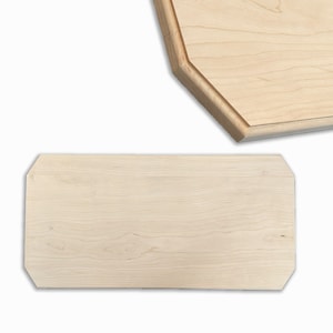 May include: Two wooden cutting boards, one rectangular and one octagonal, made of light wood with a natural grain.