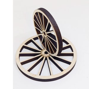 May include: Two wooden wheels with a brown stain, stacked on top of each other. The wheels have a spoke design and are made of plywood.