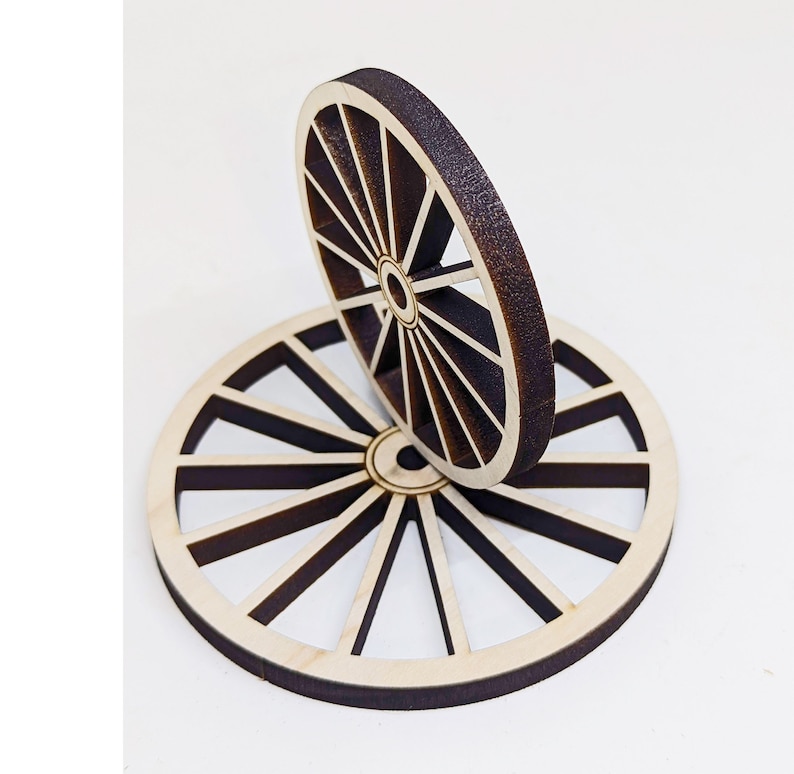 May include: Two wooden wheels with a brown stain, stacked on top of each other. The wheels have a spoke design and are made of plywood.