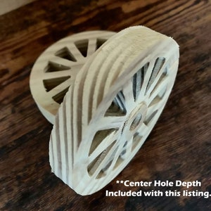 May include: Two unfinished wooden wheels with a center hole. The wheels have a spoke design and are stacked on top of each other. **Center Hole Depth Included with this listing.**