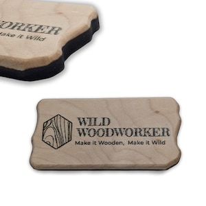 May include: Two wooden business card holders with rounded edges. The text "WILD WOODWORKER" and "Make it Wooden, Make it Wild" are printed in black. One holder has a black border.