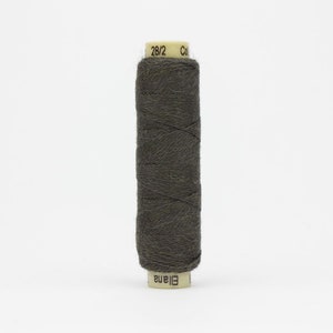 May include: A spool of dark gray thread, labeled "28/2" and "Eliana." The thread is tightly wound around a cylindrical core. This sewing supply is suitable for various textile projects.