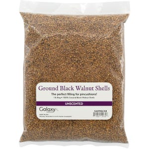 May include: A clear plastic bag filled with brown, granular ground black walnut shells. The white label reads: Ground Black Walnut Shells, The perfect filling for pincushions!, 1 lb Bag, 100% Ground Black Walnut Shells, UNSCENTED, Galaxy notions, MADE IN USA.