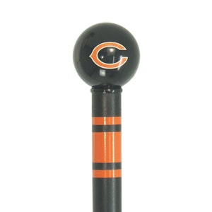 May include: Black and orange curtain rod finial with a Chicago Bears logo. The finial is a sphere with a black background and an orange "C" with a white outline.