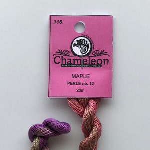 May include: A skein of Chameleon brand hand-dyed embroidery thread in the color Maple. The thread is a gradient of purple, pink, and brown. The skein is labeled "PERLE no. 12" and "20m".