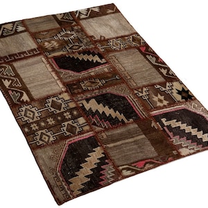 May include: A patchwork rug with a variety of geometric patterns in shades of brown, beige, and gray. The rug has a rectangular shape and is made up of several different fabric pieces sewn together. The design includes zigzags, stars, and diamond shapes.