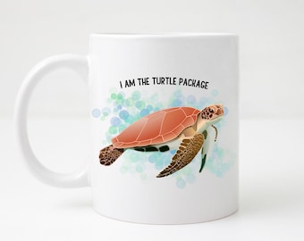 May include: White ceramic mug with a black handle. The mug has a watercolor design of a sea turtle swimming in blue and green water. The text "I am the turtle package" is printed in black on the mug.