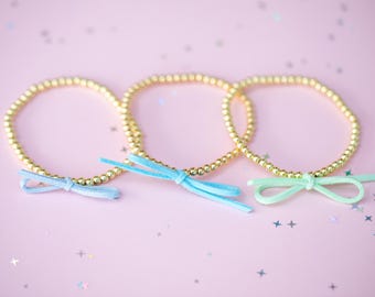 Stretch suède strikarmband met kralen - (kies kleur strik) - kies de kleur van de instelling, kleine kralen van 4 mm