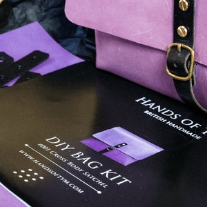 May include: A DIY bag kit with instructions and materials to make a purple cross body satchel. The kit is from Hands of Tym, a British handmade company.