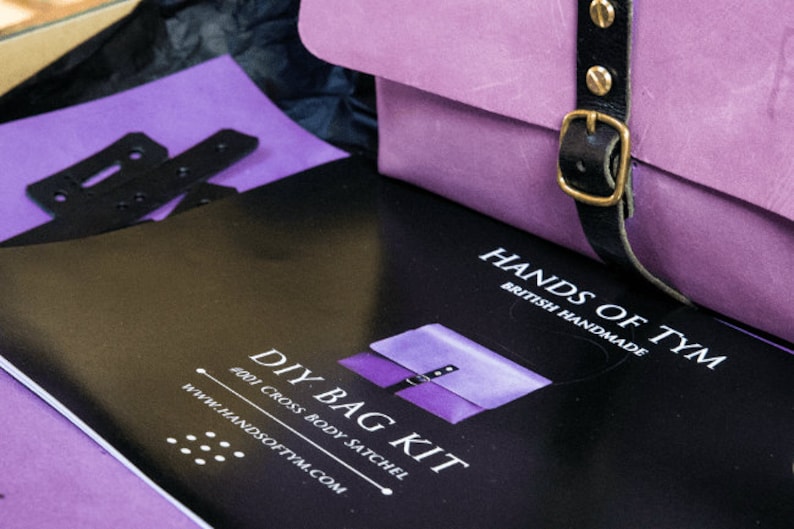 May include: A DIY bag kit with instructions and materials to make a purple cross body satchel. The kit is from Hands of Tym, a British handmade company.