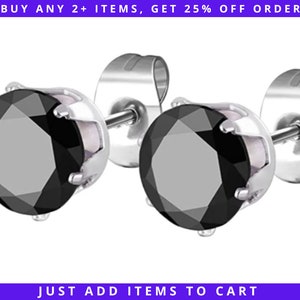May include: A pair of black stud earrings with silver settings. The earrings are made of stainless steel and have a classic design.