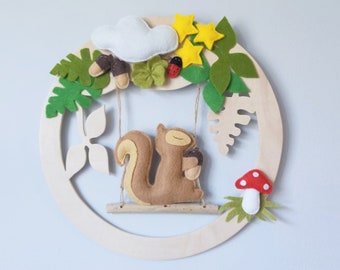 Baby mobile squirrel on swing made of driftwood and cut wood decoration