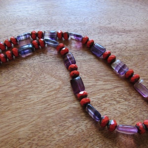 Art-deco necklace in stylish red-orange and violet shades