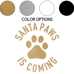 May include: A gold glitter paw print with the text "Santa Paws is Coming" in black lettering.