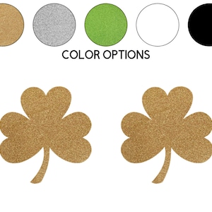 May include: Two gold glitter shamrock stickers. The shamrocks are a traditional Irish symbol.