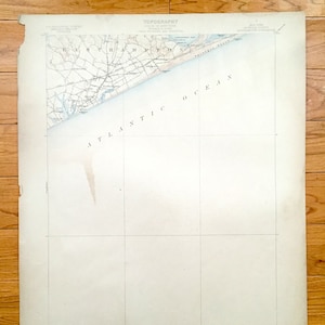 Pode incluir: Um mapa vintage da área de East Hampton em Long Island, Nova York. O mapa mostra a costa e o Oceano Atlântico. O mapa é intitulado "TOPOGRAPHY STATE OF NEW YORK COUNTY OF SUFFOLK TOWN OF EAST HAMPTON"