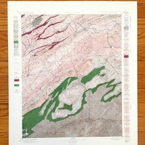 Könnte beinhalten: Eine antike geologische Karte von Blount County, Tennessee, mit einer detaillierten Legende und einem farbcodierten Schlüssel. Die Karte zeigt die verschiedenen Gesteinsformationen und geologischen Merkmale des Gebiets. Die Karte ist auf cremefarbenem Papier mit braunem Rand gedruckt.