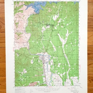 May include: A vintage topographic map of Redding, California, showing roads, rivers, and elevation contours. The map is printed on paper and has a green and brown color scheme.