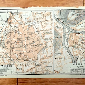 May include: A vintage map of Göttingen and Münden, Germany, with a scale of 1:17,000 and 1:25,000. The map shows the city streets, buildings, and landmarks, including the river Weser.