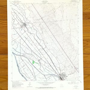 May include: A detailed topographic map with intricate line work depicting geographical features. The map includes contour lines, roads, and water bodies, with text indicating locations and elevations. The map is printed on aged paper.