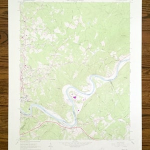 May include: A vintage topographic map of the area around the town of Clintwood, Virginia. The map shows the town, surrounding roads, rivers, and other geographical features. The map is printed on a white background with green, brown, and blue lines and text.