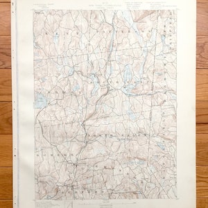 May include: A vintage topographic map of the New York-Connecticut border, showing the towns of Kent, Patterson, Southeast, North Salem, Somers, and Bedford. The map is printed on cream-coloured paper and features brown contour lines and blue water features.