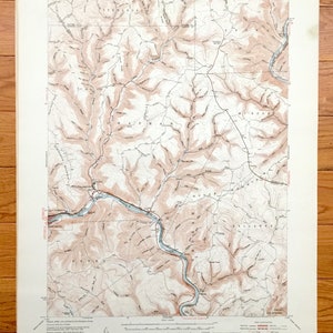 May include: A vintage topographic map of the Renovo East Quadrangle in Pennsylvania. The map shows the area's terrain, rivers, and roads. The map is printed on paper and has a brown and white color scheme.