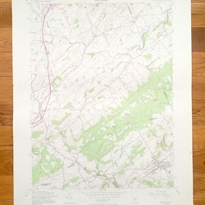 May include: A vintage topographic map of the United States Geological Survey, showing the area around Woodhull, New York. The map is printed in black and white with green and blue accents. The map includes details such as roads, rivers, and elevation contours.