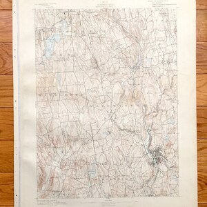 May include: A vintage map of Waterbury, Connecticut, showing the surrounding towns and geographical features. The map is printed in black and white on a cream-colored paper. The map is titled "Connecticut Waterbury Quadrangle" and includes the text "State of Connecticut, U.S. Geological Survey, 1903".