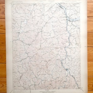May include: A vintage topographic map of Kentucky and West Virginia, showing rivers, roads, and towns. The map is printed on paper and has a light brown colour.