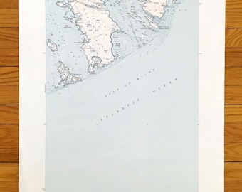 May include: A vintage map of Great Wass Island, Maine, showing the coastline and surrounding islands. The map is printed on a light blue background with black lines and text. The map is titled "Great Wass Island Quadrangle" and includes the text "United States Department of the Interior Geological Survey" and "Gulf of Maine Atlantic Ocean".