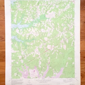 May include: A vintage topographic map of New Hill, North Carolina, showing roads, rivers, and other geographical features. The map is printed on white paper with green, brown, and blue lines and text. The map is titled "New Hill, North Carolina" and includes a scale bar and compass rose.