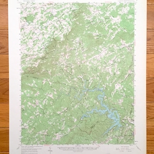 May include: A vintage topographic map of the Trinity Alps State Park in California. The map shows the park's trails, roads, and elevation contours. The map is printed on a white background with green and blue lines.