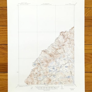 May include: A vintage topographic map with brown and tan shaded relief, showing geographical features. The map includes place names and grid lines, printed on aged paper. The map is a detailed representation of a specific area.