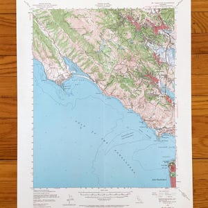 May include: A detailed topographic map of the San Francisco Bay Area, featuring the Gulf of the Farallones and San Francisco. The map uses a color-coded system to represent elevation and geographical features. The map is printed on white paper.