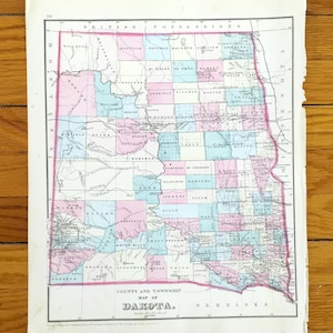 May include: A vintage map of Dakota, showing county and township details. The map is divided into sections with pink and blue hues, outlined in red. The title "COUNTY AND TOWNSHIP MAP OF DAKOTA" is visible at the bottom.