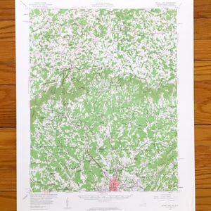 May include: A United States Geological Survey topographic map of the Mount Airy quadrangle in Virginia and North Carolina. The map features detailed green shaded terrain, contour lines, roads, and text labels for geographic locations.