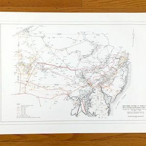 May include: A vintage map titled "Main Power Systems of Pennsylvania with System Interconnections Map." The map features a detailed network of power lines in red, black, and gray, with text and a legend. The map is printed on white paper.