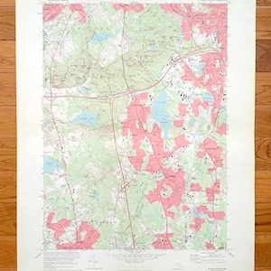 May include: A vintage topographic map of Blue Hills, Massachusetts, showing roads, rivers, and landmarks. The map is printed on paper and has a light brown colour. The map is titled "Blue Hills Quadrangle" and includes the text "Commonwealth of Massachusetts Department of Public Works".