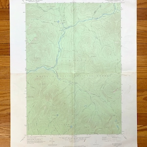 May include: A vintage topographic map of the Mt. Osceola quadrangle in New Hampshire. The map shows the White Mountain National Forest, with green contour lines indicating elevation changes. The map is printed on paper and has a light green background.
