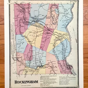May include: Antique map of Rockingham, featuring a detailed depiction of the town's districts and geographical features. The map is colored in pastel hues, with roads and rivers clearly marked. The title "Rockingham" is prominently displayed at the bottom.