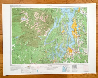 May include: A vintage map of Seattle, Washington, showing the city's geography and surrounding areas. The map is printed on paper and has a light blue and green color scheme. The map is titled "Seattle" and includes the text "Western United States 1:250,000".